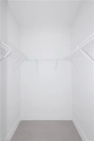 Spacious closet featuring tile patterned flooring