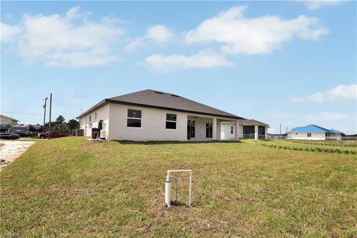 Back of house with a lawn