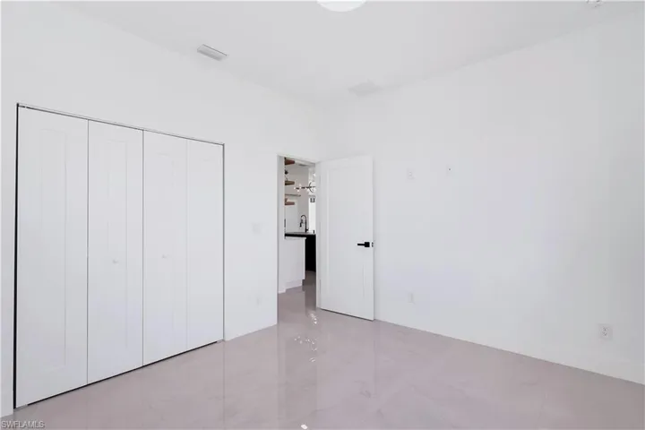 Unfurnished bedroom with light tile patterned flooring and a closet