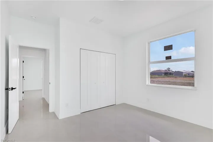 Unfurnished bedroom with a closet and tile patterned floors