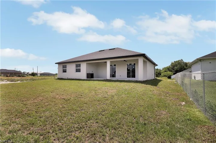 Rear view of property featuring a yard