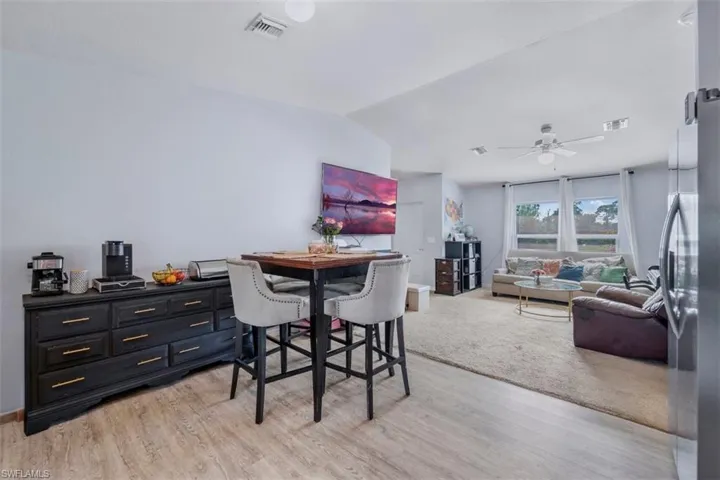 Dining space featuring lofted ceiling, light wood-type flooring, and ceiling fan