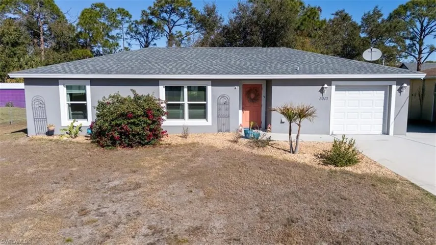Single story home with roof with shingles, stucco siding, driveway, and an attached garage