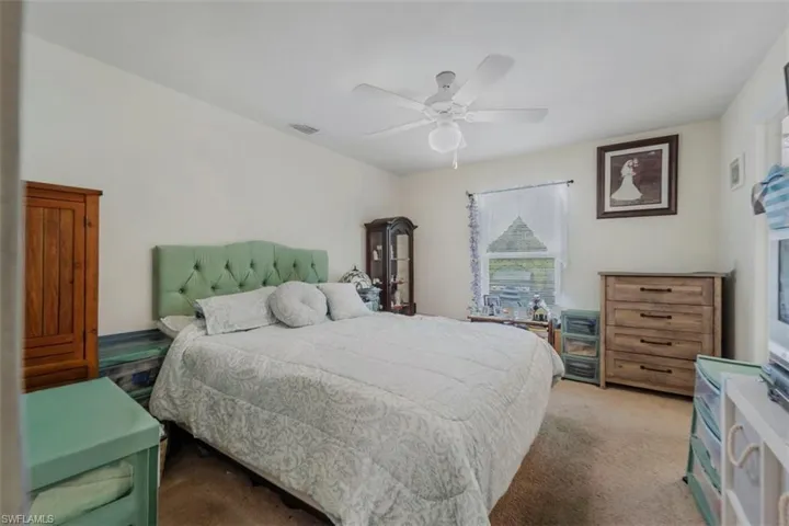 Carpeted bedroom with ceiling fan
