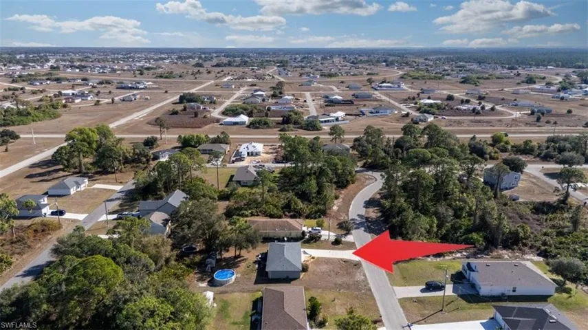 Aerial view of property's location with nearby suburban area