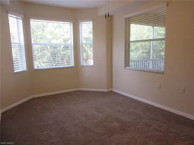 Primary bedroom with window overlooking spacious lanai