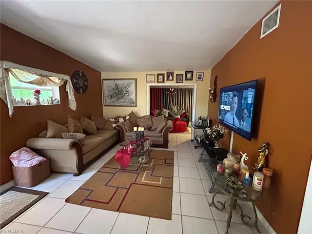 Living room with light tile patterned floors