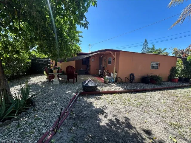 Rear view of house featuring stucco siding and a patio area