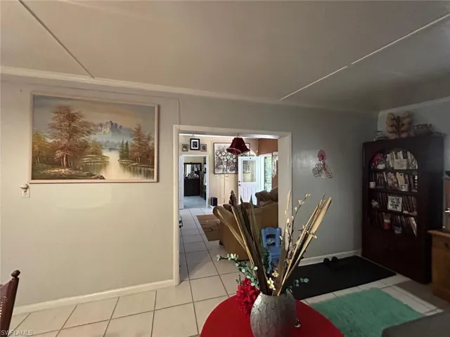 Dining room featuring light tile patterned floors and baseboards