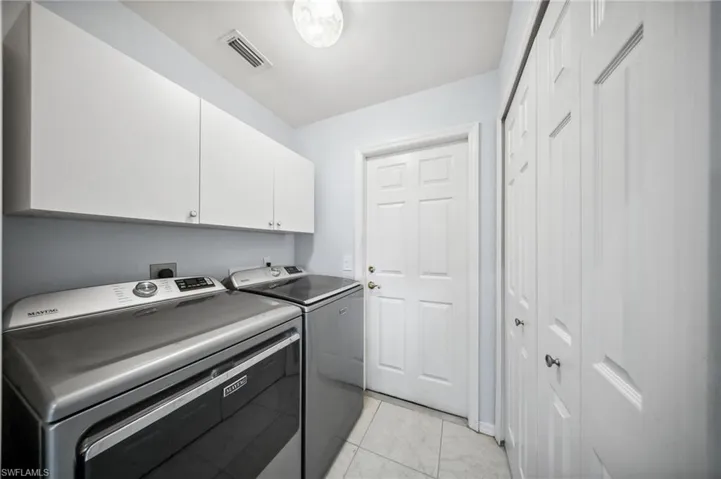 Laundry room with cabinets and pantry