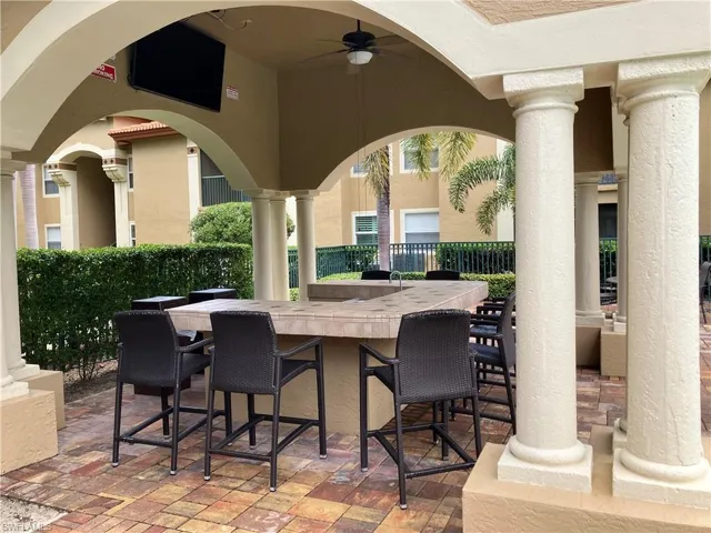 RESIDENTS POOLSIDE GATHERING AREA AROUND "BRING YOUR OWN" BAR AND LARGE SCREEN TV....