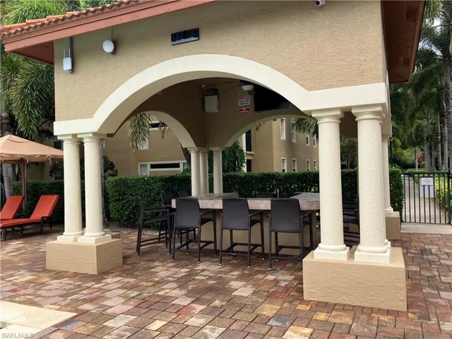 RESIDENTS POOLSIDE GATHERING AREA AROUND BAR AND LARGE SCREEN TV....