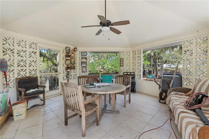 Sunroom / solarium with vaulted ceiling and ceiling fan