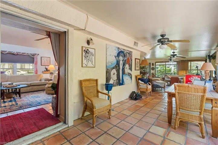 Sunroom featuring a ceiling fan and visible vents