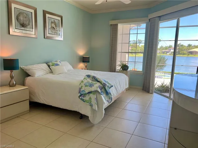 Large Primary bedroom with views of the pool and lake