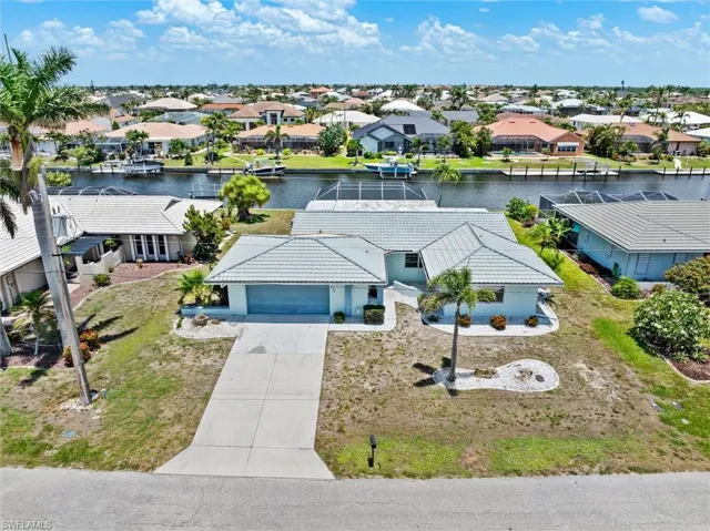 Aerial view of residential area featuring a nearby body of water
