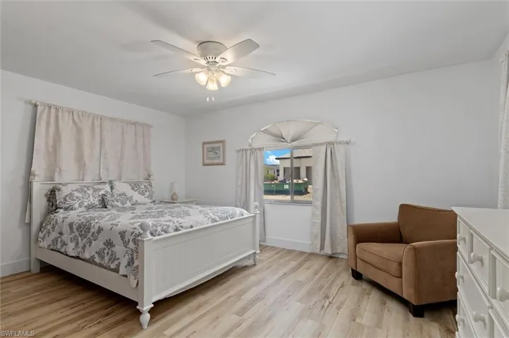 Guest Bedroom featuring light wood-style flooring and ceiling fan