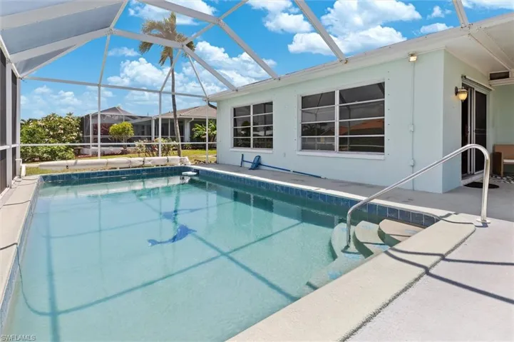 Swimming pool featuring a patio and glass enclosure