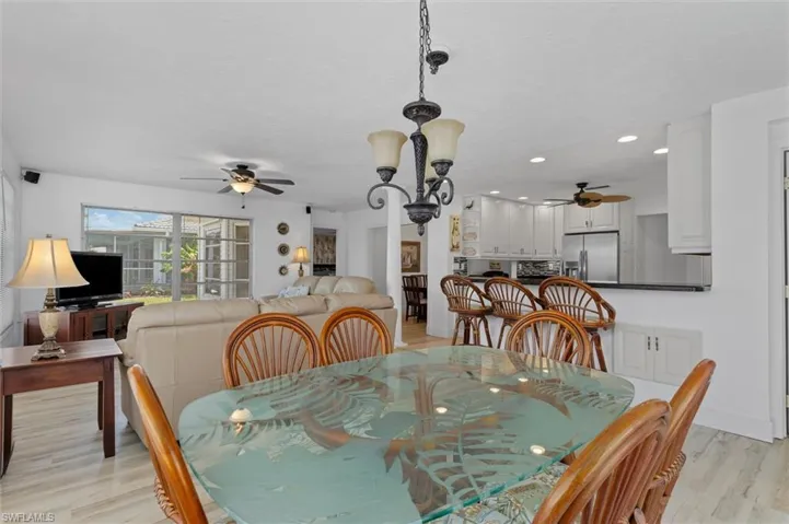 Dining space with light wood finished floors, recessed lighting, and a ceiling fan