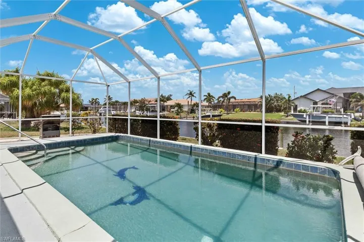 Outdoor pool featuring a water view and a lanai