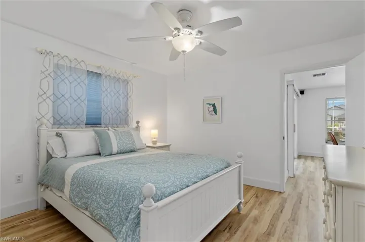 Guest Bedroom featuring light wood finished floors and a ceiling fan