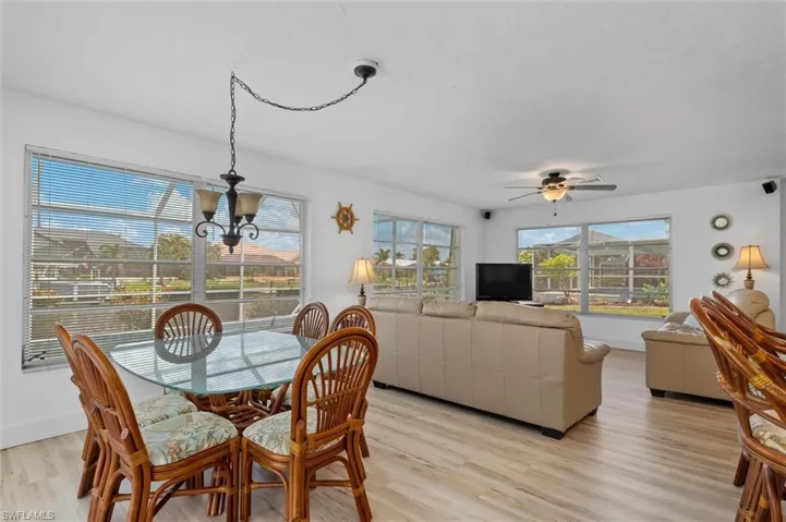 Dining space featuring a chandelier, light wood-style flooring, and a ceiling fan