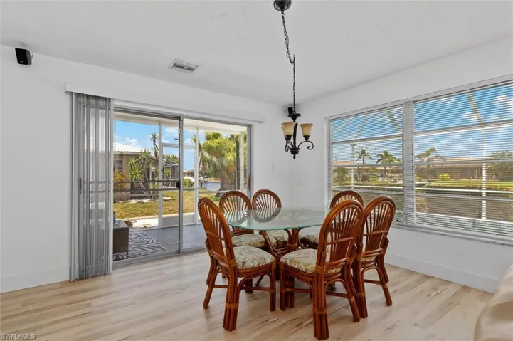 Dining area featuring light wood-style floors and a chandelier