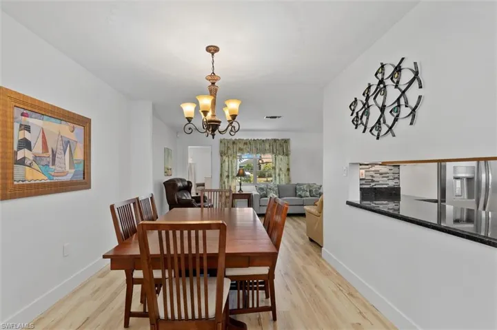 Dining area featuring light wood-style floors and a chandelier