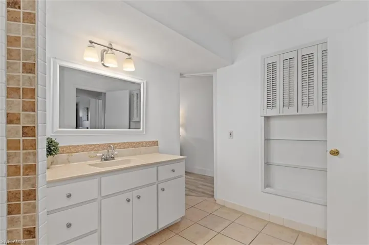 Bathroom featuring tile patterned floors and vanity