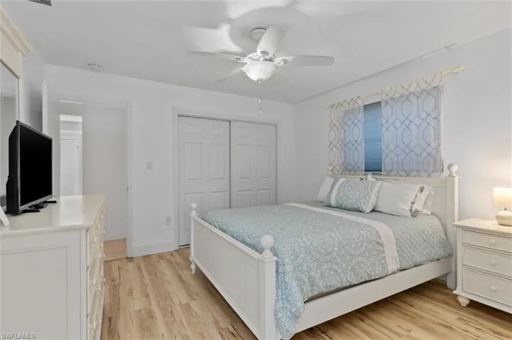 Guest Bedroom featuring a closet, light wood finished floors, and a ceiling fan