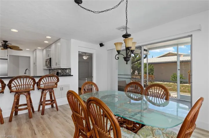 Dining room featuring light wood finished floors, recessed lighting, and a chandelier