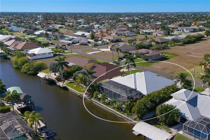 Aerial perspective of suburban area featuring a large body of water