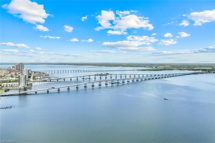 Aerial view of a nearby body of water and a notable bridge