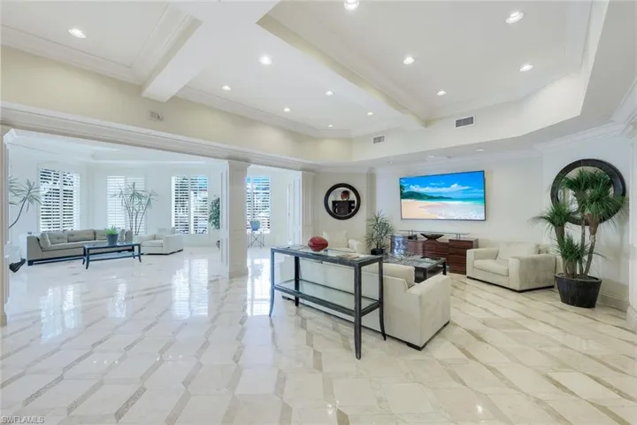 Lobby featuring ornamental molding, recessed lighting, and beamed ceiling