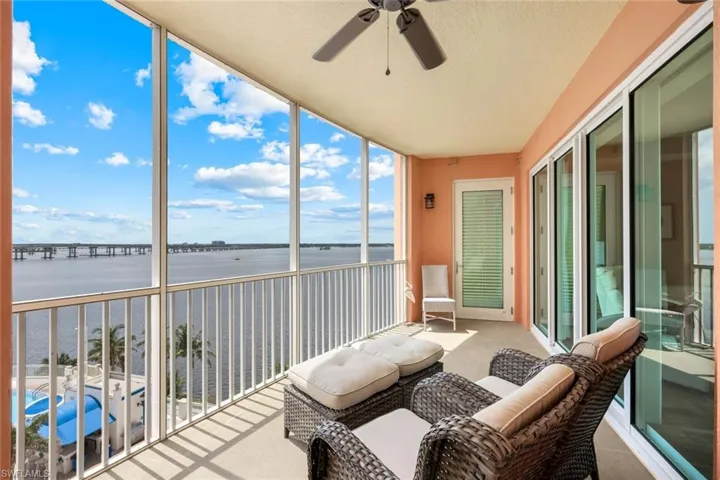 Sunroom / solarium with a water view and a ceiling fan