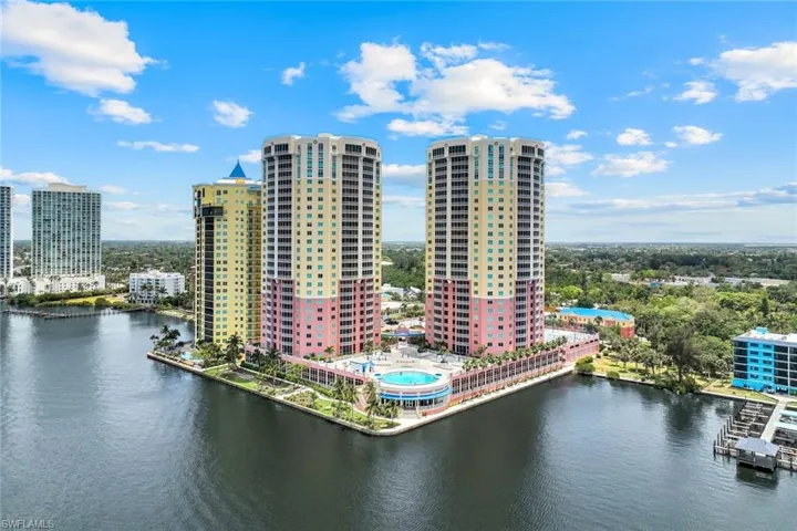 View of urban area featuring a large body of water and a pool