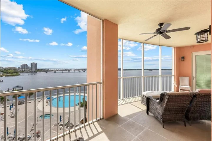 Balcony featuring a water view and ceiling fan