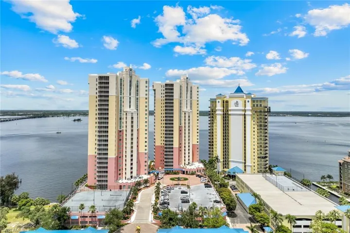 View of property featuring a water view and a view of city