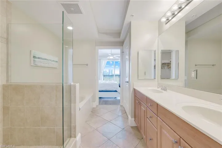 Ensuite bathroom with a stall shower and double vanity