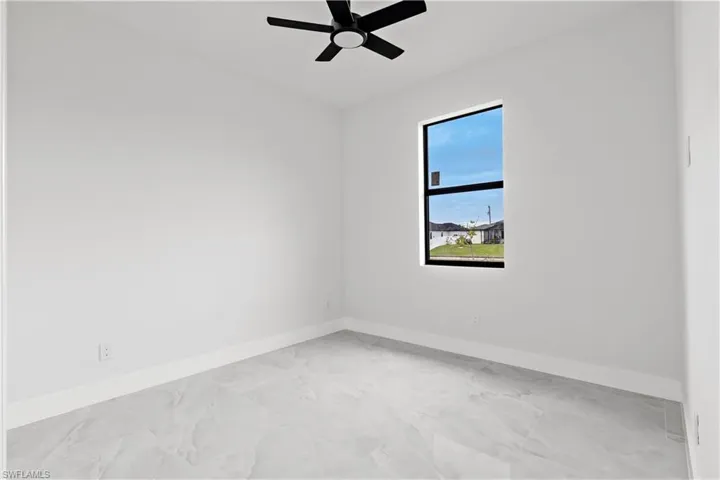 Empty room featuring ceiling fan