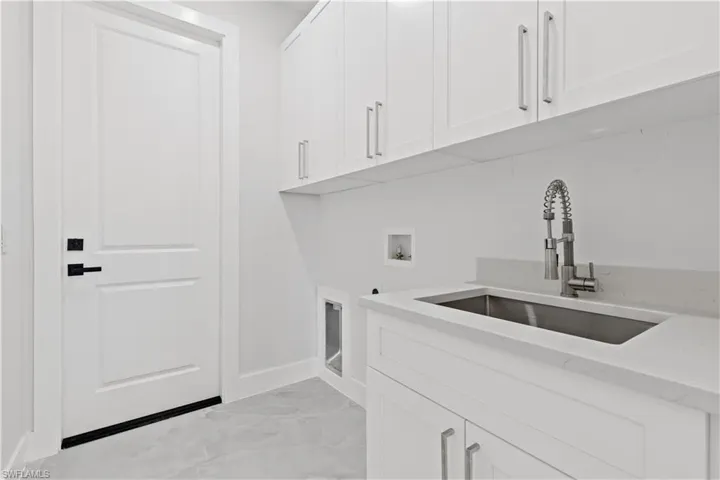 Laundry area featuring cabinets, sink, and hookup for a washing machine