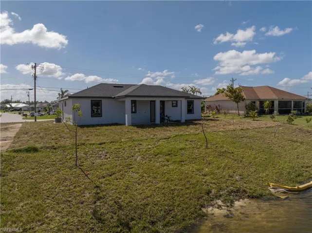 Back of property featuring a yard