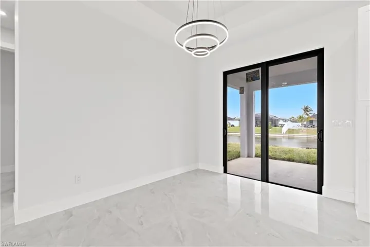 Unfurnished room with a water view and an inviting chandelier