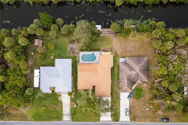 Birds eye view of property with a water view