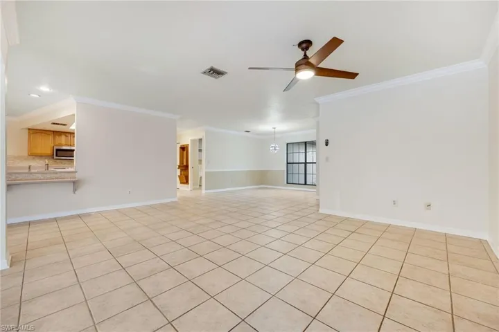 Spare room featuring ceiling fan and ornamental molding