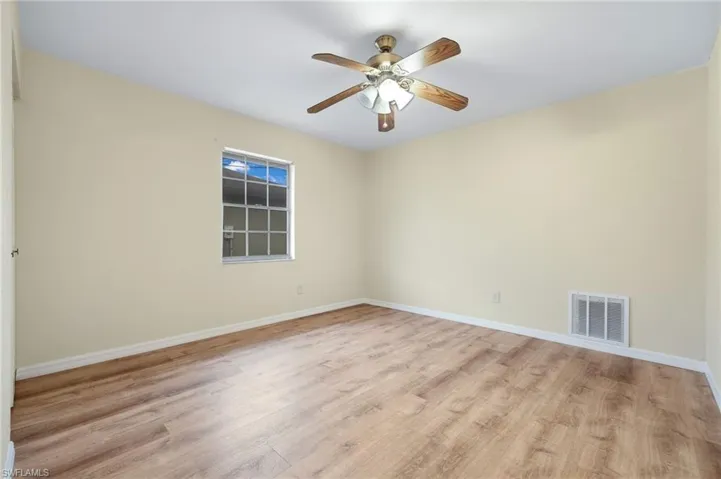 Empty room with light hardwood / wood-style floors and ceiling fan