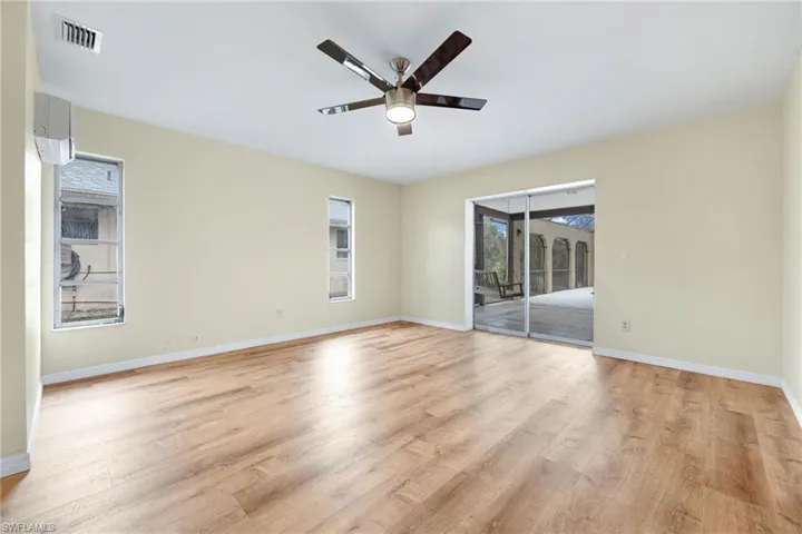 Empty room with ceiling fan and light wood-type flooring