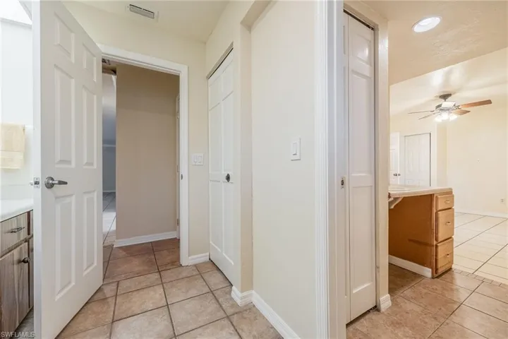 Corridor with light tile patterned floors