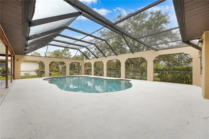 View of pool with a lanai and a patio area