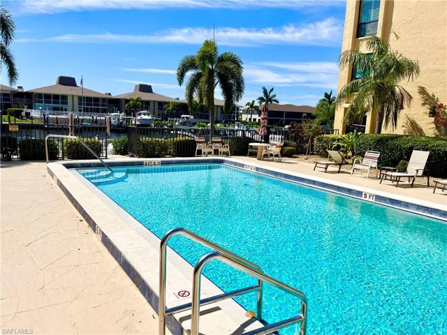 View of swimming pool featuring a patio area and a water view